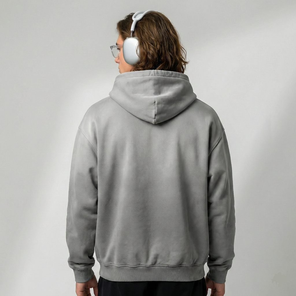 Person wearing a gray hoodie from behind on a plain background